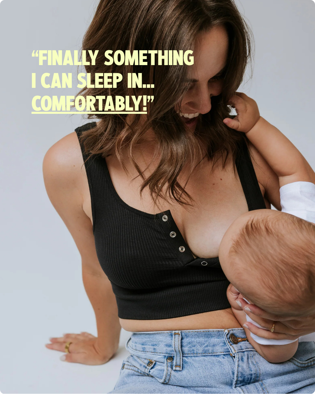 Mom breastfeeding her baby in the Allie Bra, a soft nursing bra with easy one-hand access that's comfortable enough to sleep in
