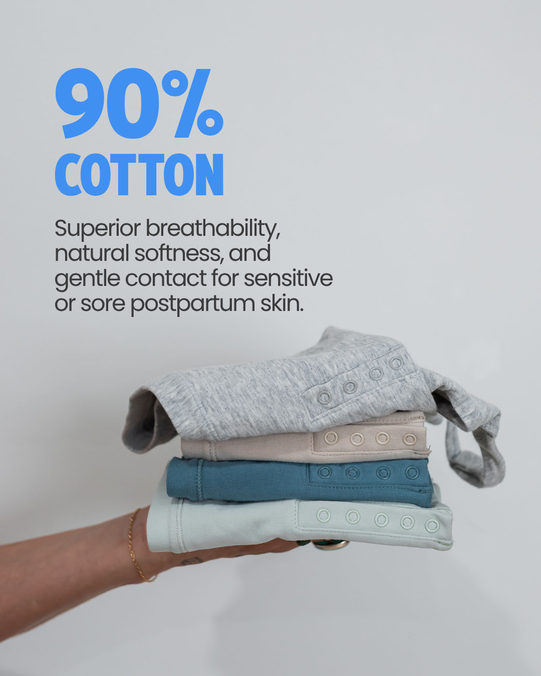 Stack of folded Angel Bra cotton nursing bras in four colors, 90% cotton for breathability and softness on sensitive postpartum skin
