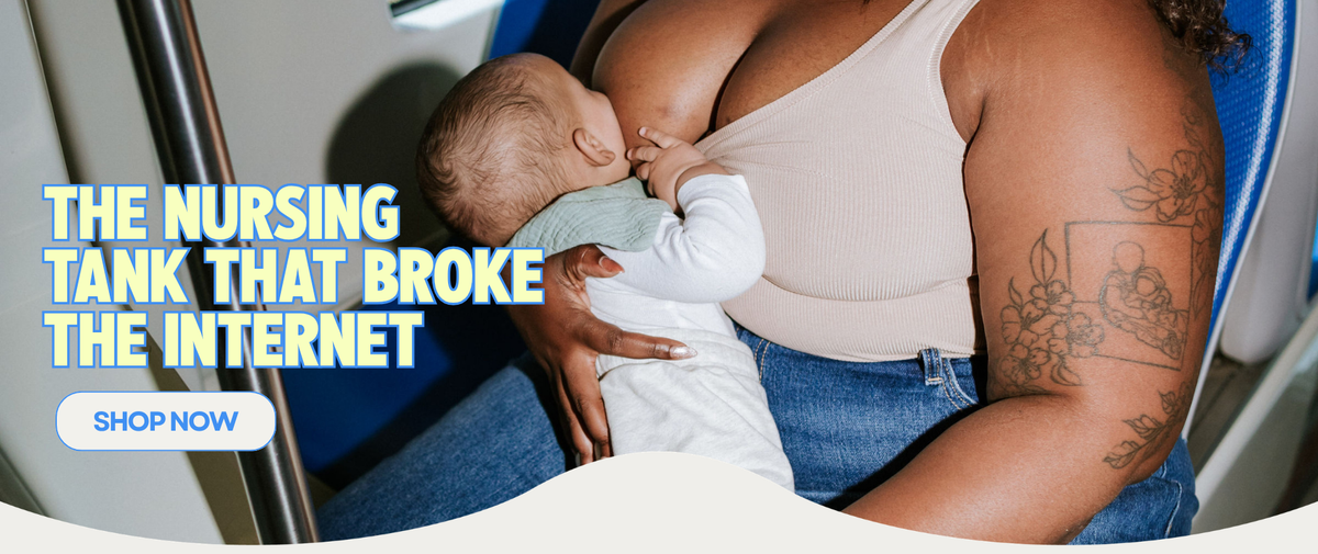 Mom breastfeeding her baby on a train wearing The Little Milk Bar nursing tank